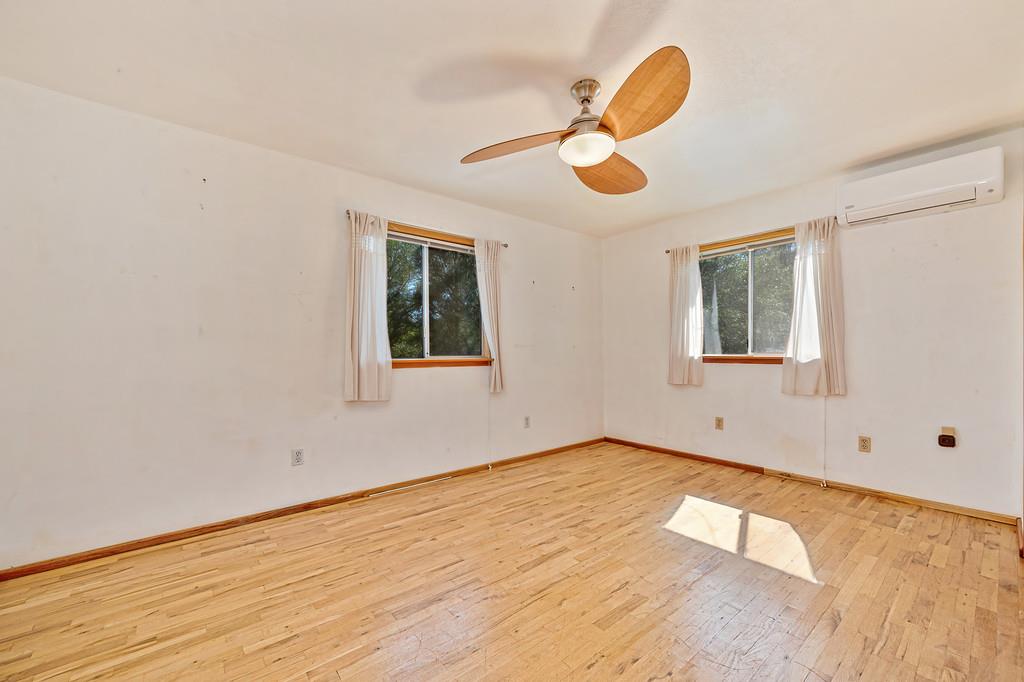 4751 Meadowview Acres Road Cool, CA 95614 - Photo 28 of 51 a view of an empty room with wooden floor and a window