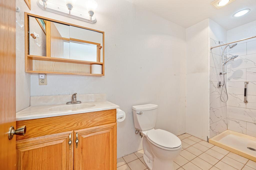 4751 Meadowview Acres Road Cool, CA 95614 - Photo 32 of 51 a bathroom with a granite countertop sink toilet a mirror and shower
