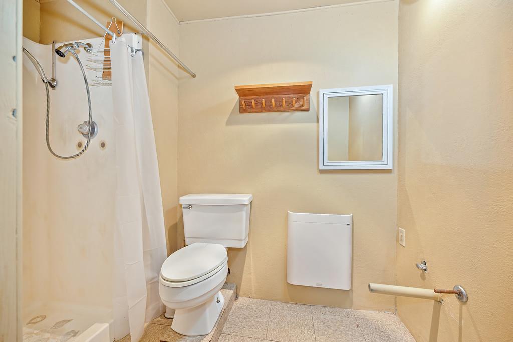 4751 Meadowview Acres Road Cool, CA 95614 - Photo 45 of 51 a white toilet sitting next to a bathroom sink and a shower