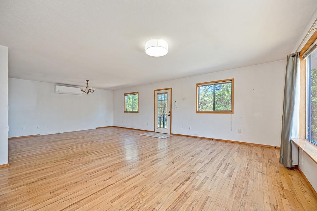 4751 Meadowview Acres Road Cool, CA 95614 - Photo 9 of 51 an empty room with wooden floor and windows