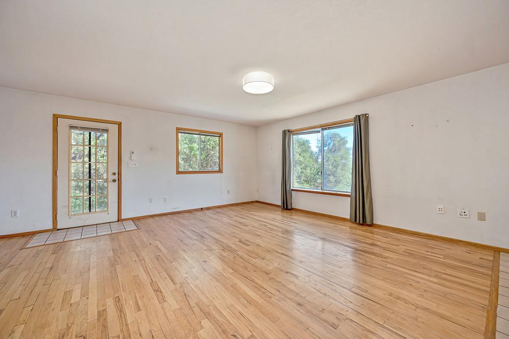 4751 Meadowview Acres Road Cool, CA 95614 - Photo 10 of 51 a view of an empty room with wooden floor and a window