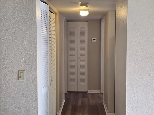 a view of a hallway with wooden floor