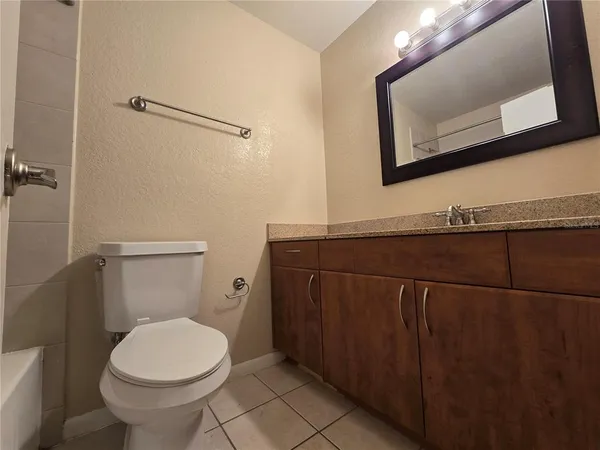 a bathroom with a sink a toilet and mirror
