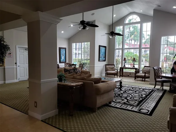 a living room with furniture and a chandelier