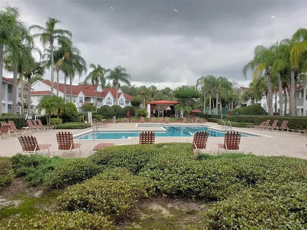 a swimming pool with outdoor seating and yard