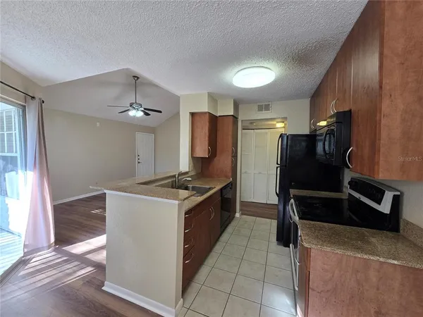 a kitchen with granite countertop a refrigerator and a stove
