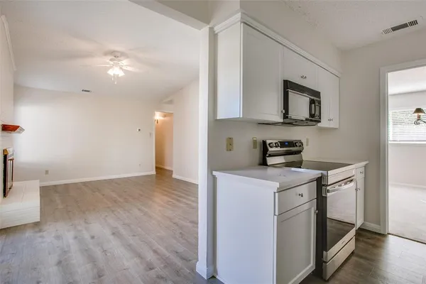 a view of a kitchen with electric appliances