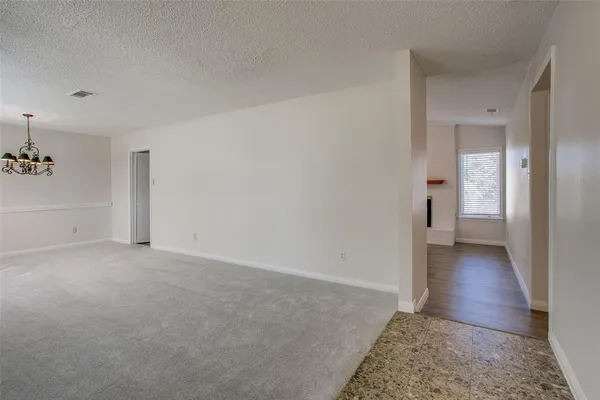 a view of an empty room and wooden floor