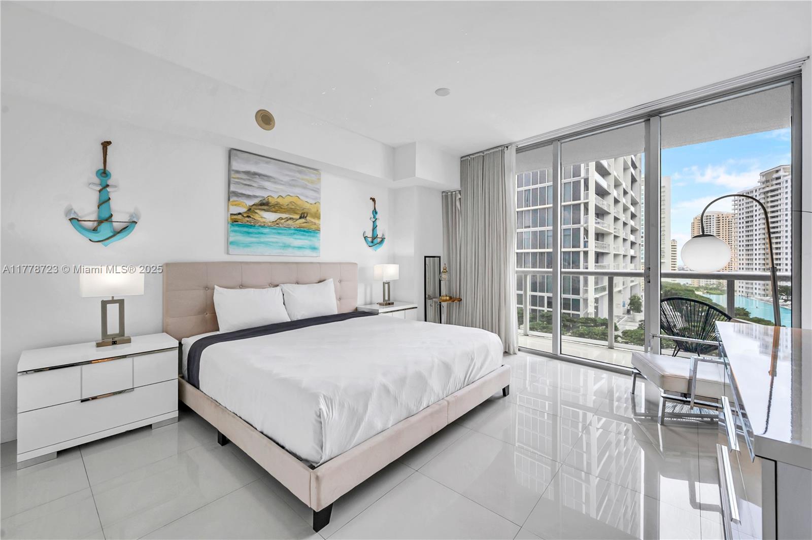 485 Brickell Avenue, Unit 1711 Miami, FL 33131 - Photo 14 of 15 a bedroom with a large bed and a painting on the wall