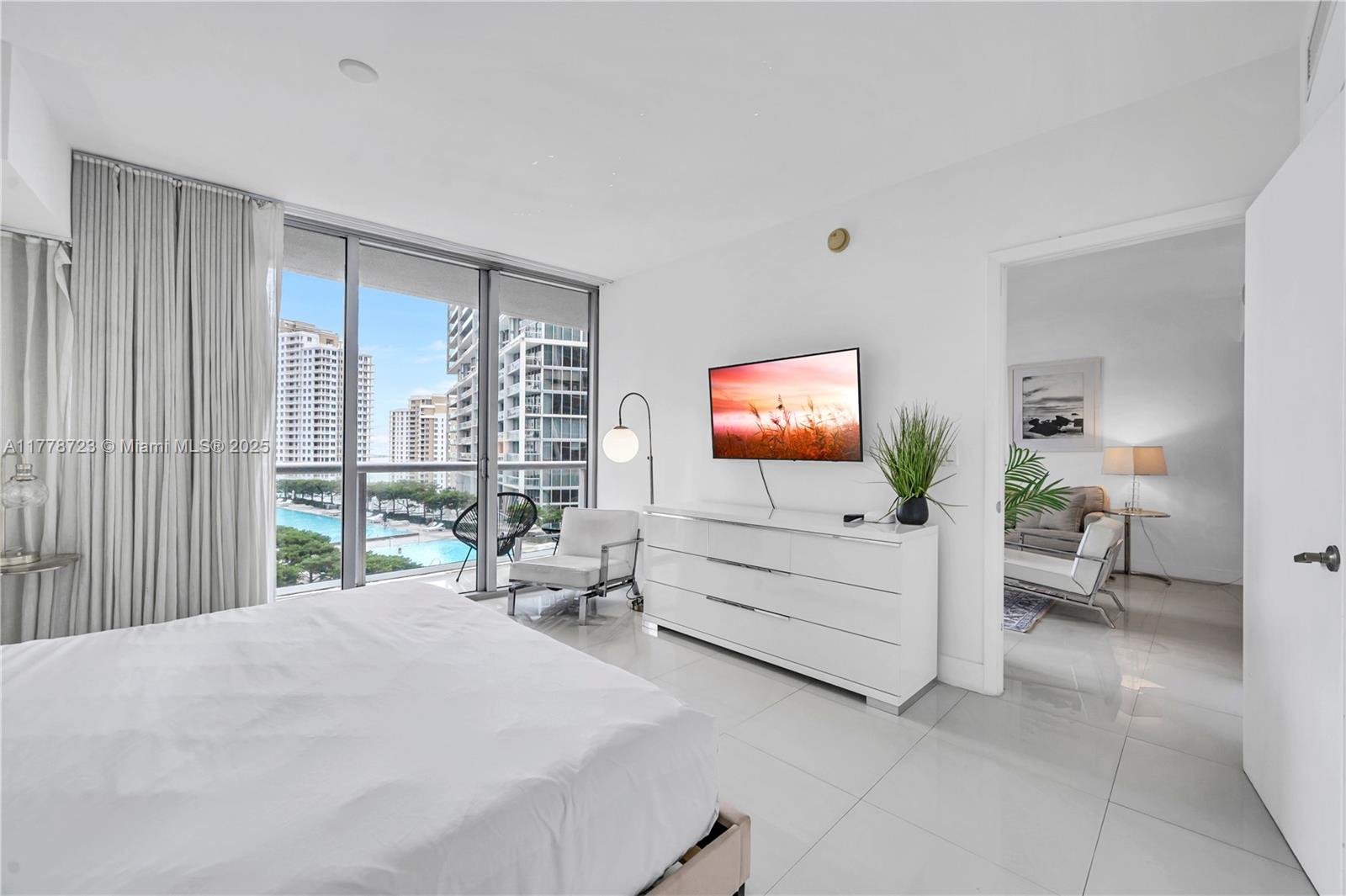 485 Brickell Avenue, Unit 1711 Miami, FL 33131 - Photo 15 of 15 a bedroom with a bed and a flat screen tv