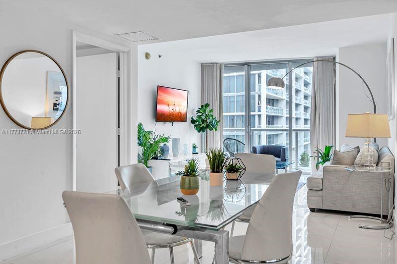 485 Brickell Avenue, Unit 1711 Miami, FL 33131 - Photo 3 of 15 a dining room with furniture and wooden floor