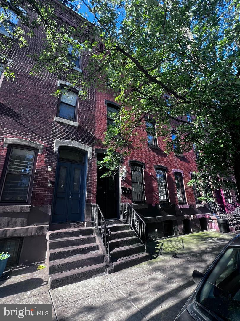 1706 West Diamond Street, Unit 3 Philadelphia, PA 19121 - Photo 2 of 3 a view of a building with a tree