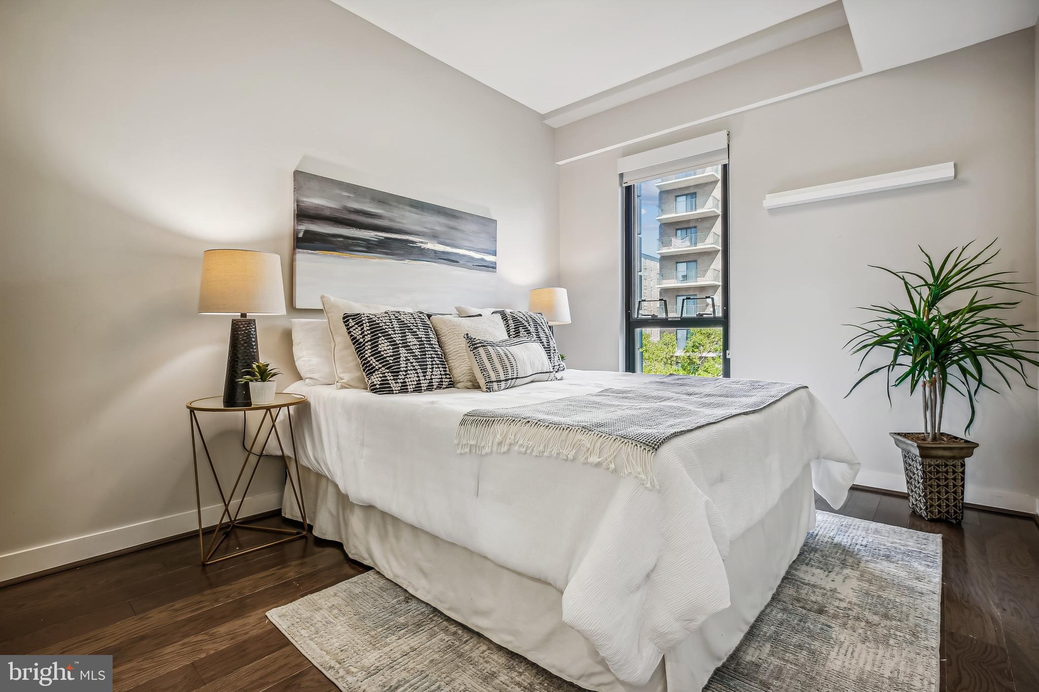 1320 Fenwick Lane, Unit 800 Silver Spring, MD 20910 - Photo 20 of 54 a bedroom with a bed and a potted plant