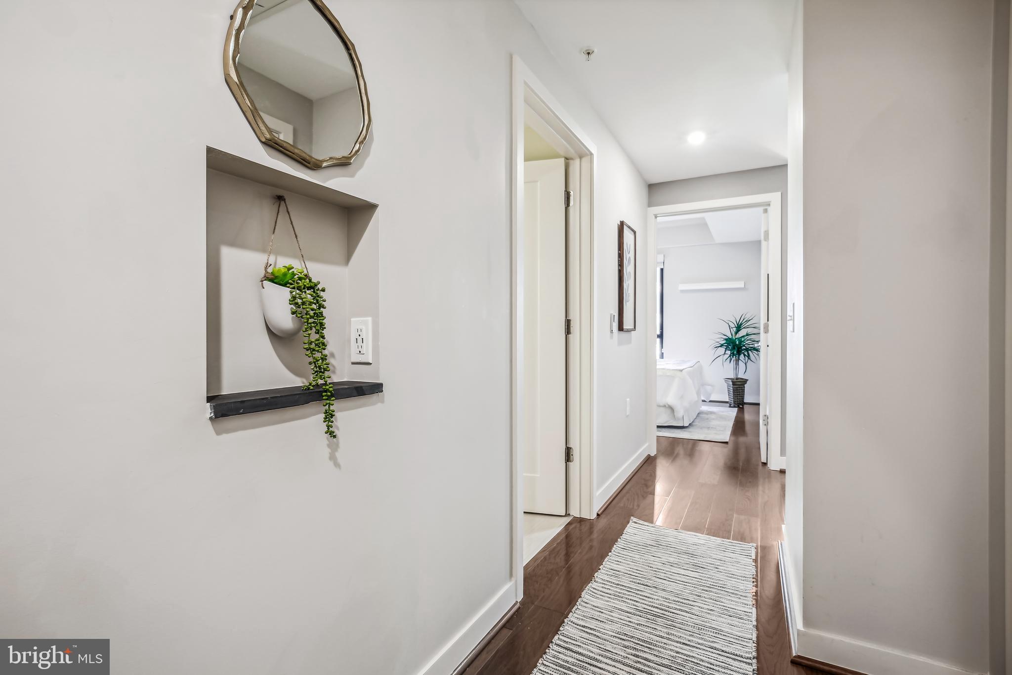 1320 Fenwick Lane, Unit 800 Silver Spring, MD 20910 - Photo 2 of 54 a view of a hallway with wooden floor and a bathroom