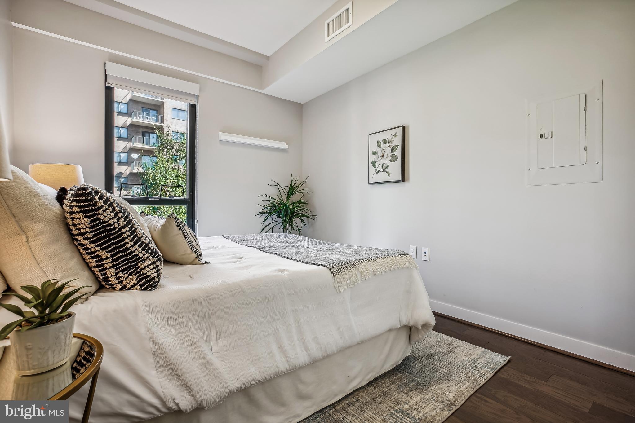 1320 Fenwick Lane, Unit 800 Silver Spring, MD 20910 - Photo 21 of 54 a bedroom with a bed and wooden floor