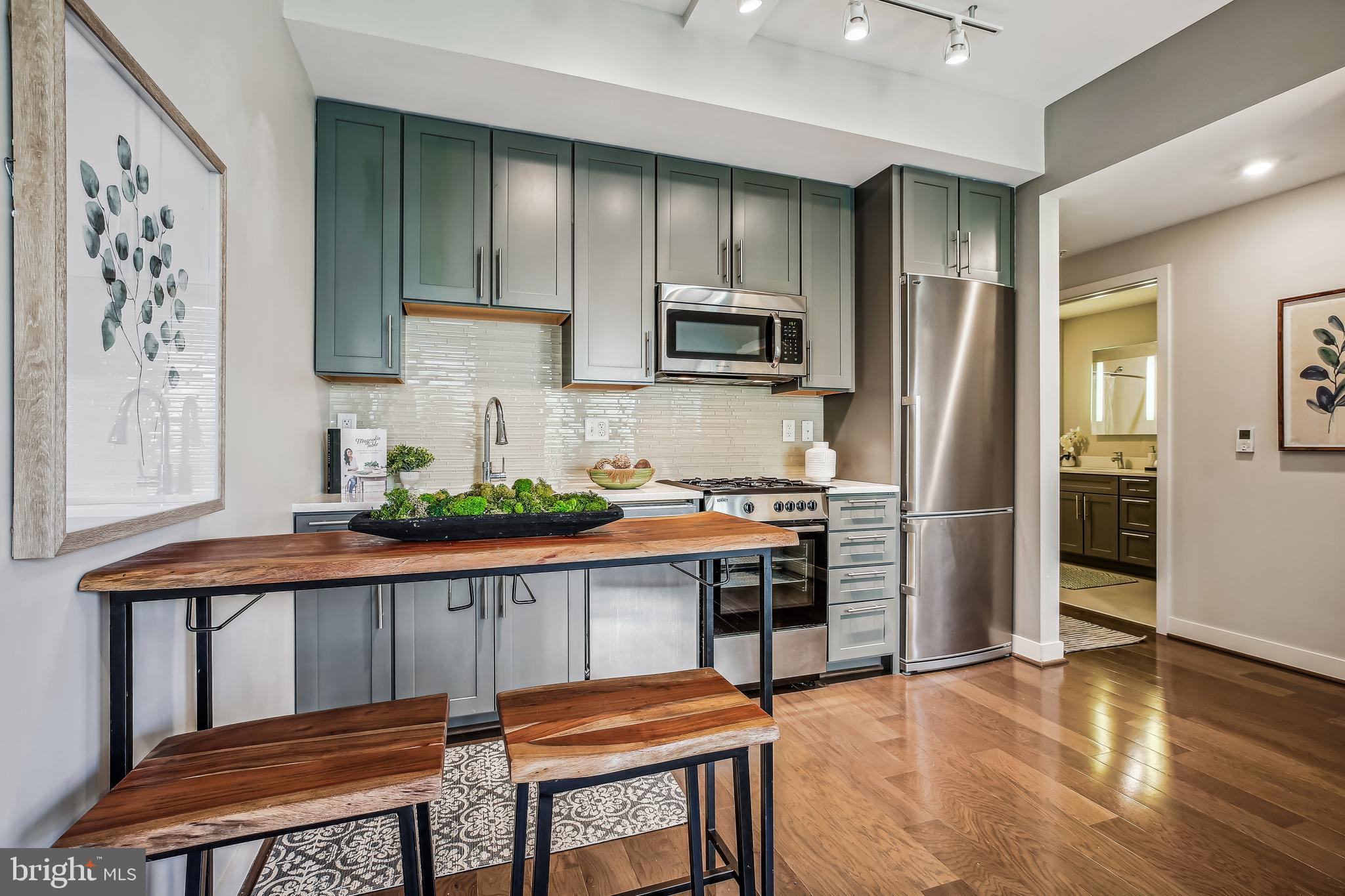 1320 Fenwick Lane, Unit 800 Silver Spring, MD 20910 - Photo 10 of 54 a kitchen with stainless steel appliances a refrigerator and a stove top oven