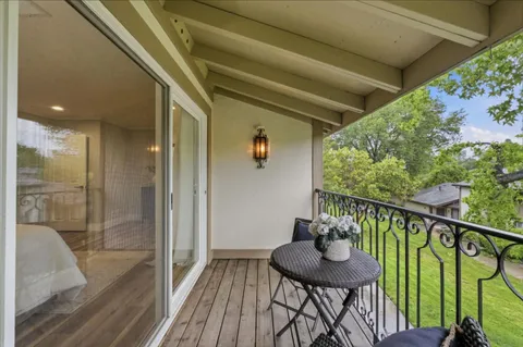 a view of balcony with furniture and wooden floor