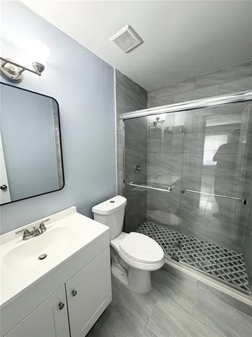 a white toilet sitting next to a bathroom sink