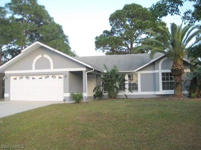 18229 Apple Road Fort Myers, FL 33967 - Photo 1 of 24 a front view of a house with a yard and garage