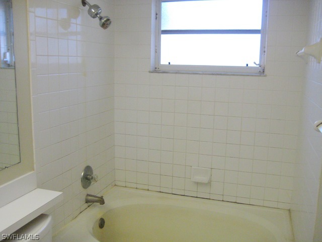 18229 Apple Road Fort Myers, FL 33967 - Photo 14 of 24 a bathroom with a tub and a window
