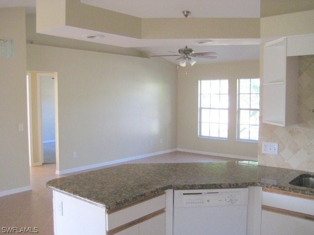 18229 Apple Road Fort Myers, FL 33967 - Photo 24 of 24 a kitchen with granite countertop cabinets and window