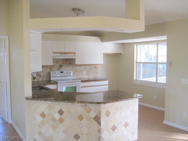 18229 Apple Road Fort Myers, FL 33967 - Photo 3 of 24 a kitchen with stainless steel appliances granite countertop a sink stove and window