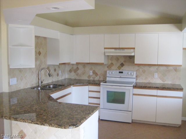 18229 Apple Road Fort Myers, FL 33967 - Photo 5 of 24 a kitchen with sink a stove and cabinets