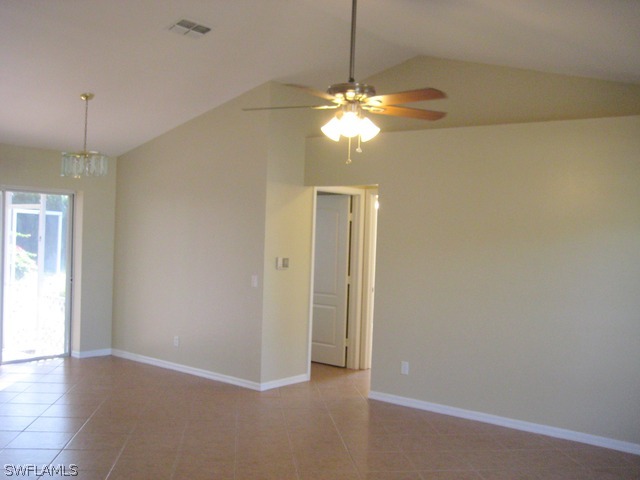 18229 Apple Road Fort Myers, FL 33967 - Photo 7 of 24 a view of a chandelier fan and hardwood floor