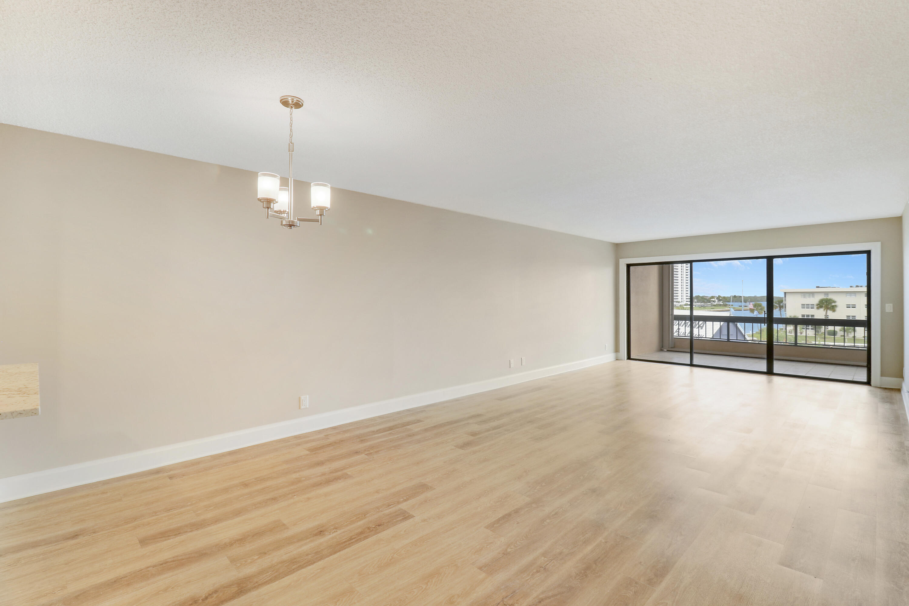 1036 Highway 1, Unit 321 North Palm Beach, FL 33408 - Photo 19 of 40 a view of an empty room with wooden floor and a window