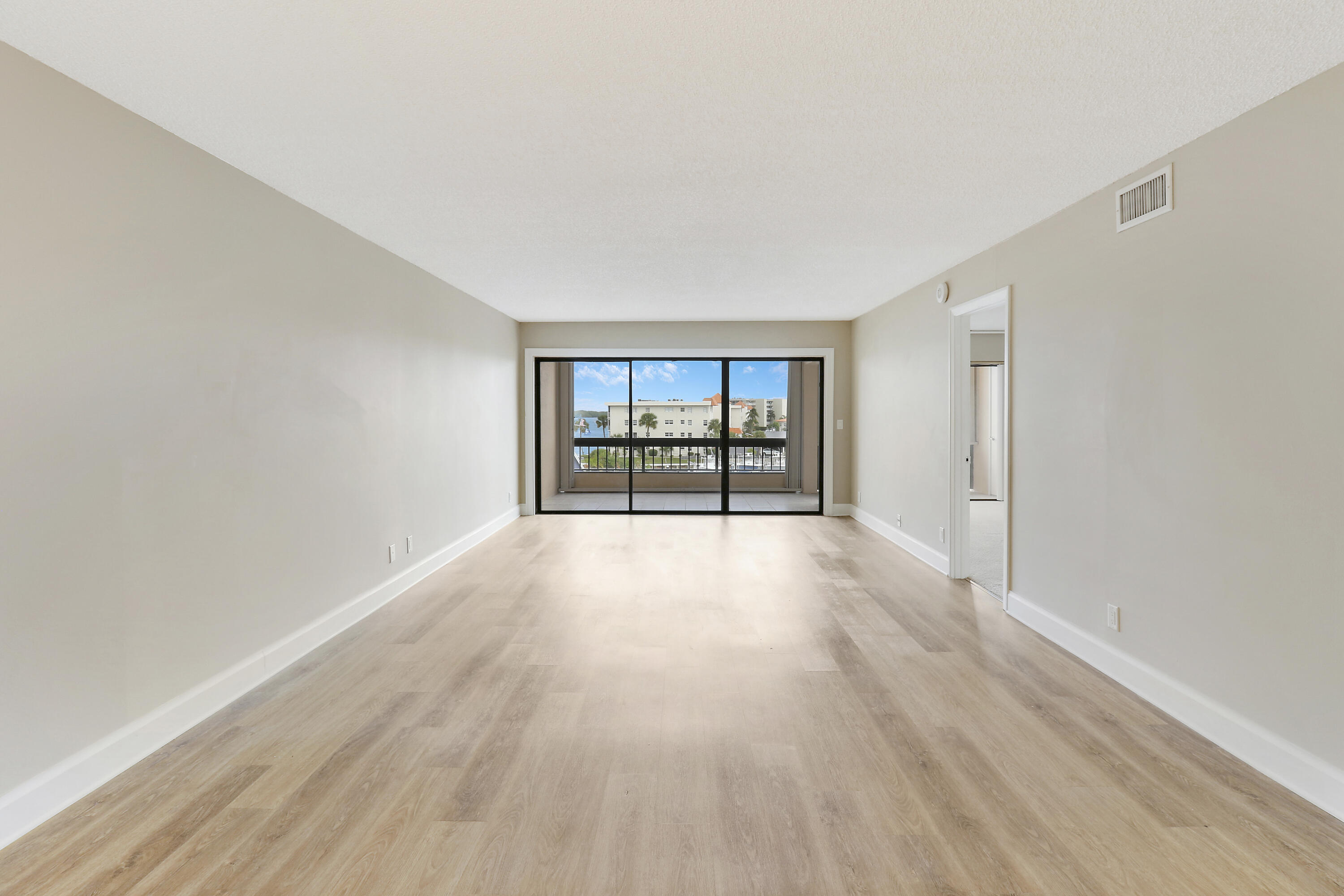 1036 Highway 1, Unit 321 North Palm Beach, FL 33408 - Photo 22 of 40 wooden floor in an empty room with a window