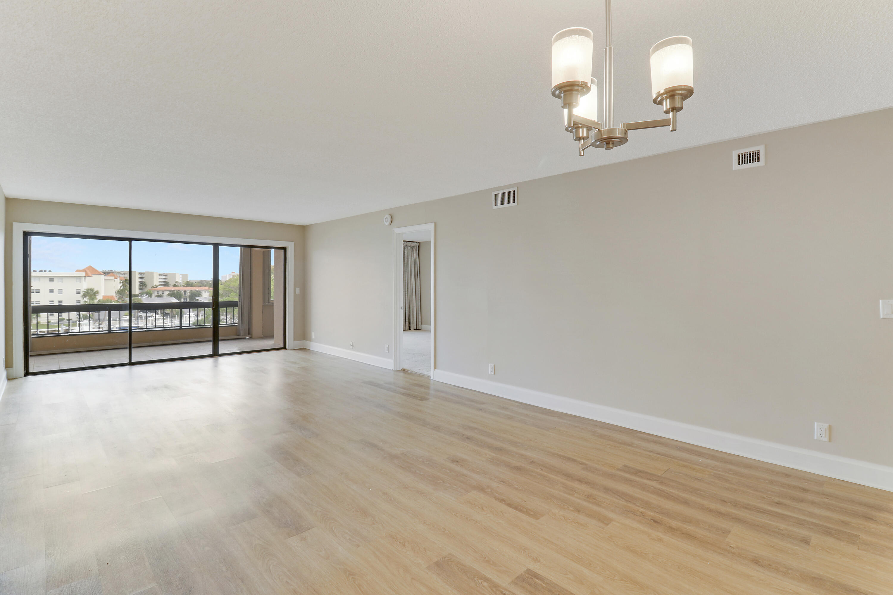 1036 Highway 1, Unit 321 North Palm Beach, FL 33408 - Photo 23 of 40 wooden floor in an empty room with a window
