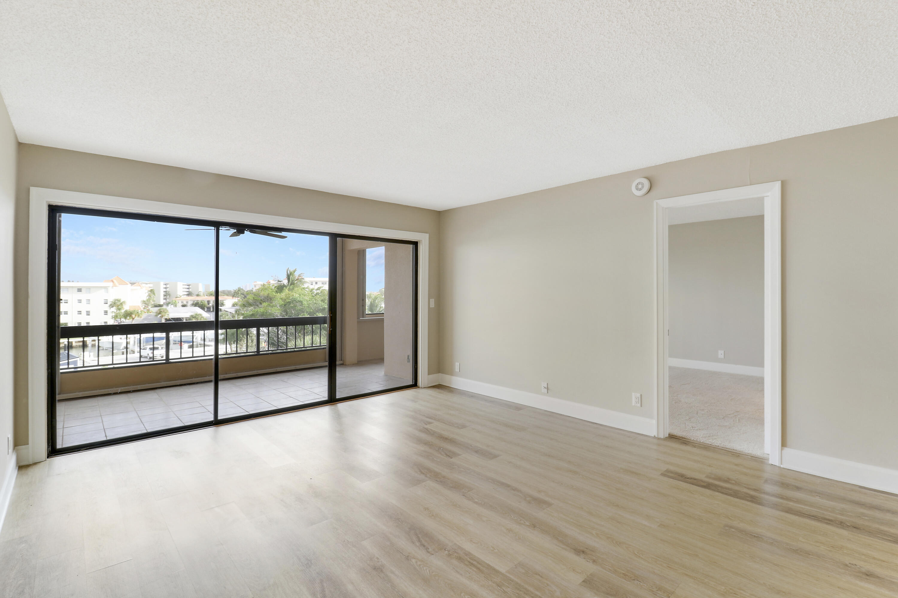 1036 Highway 1, Unit 321 North Palm Beach, FL 33408 - Photo 24 of 40 wooden floor in an empty room with a large window