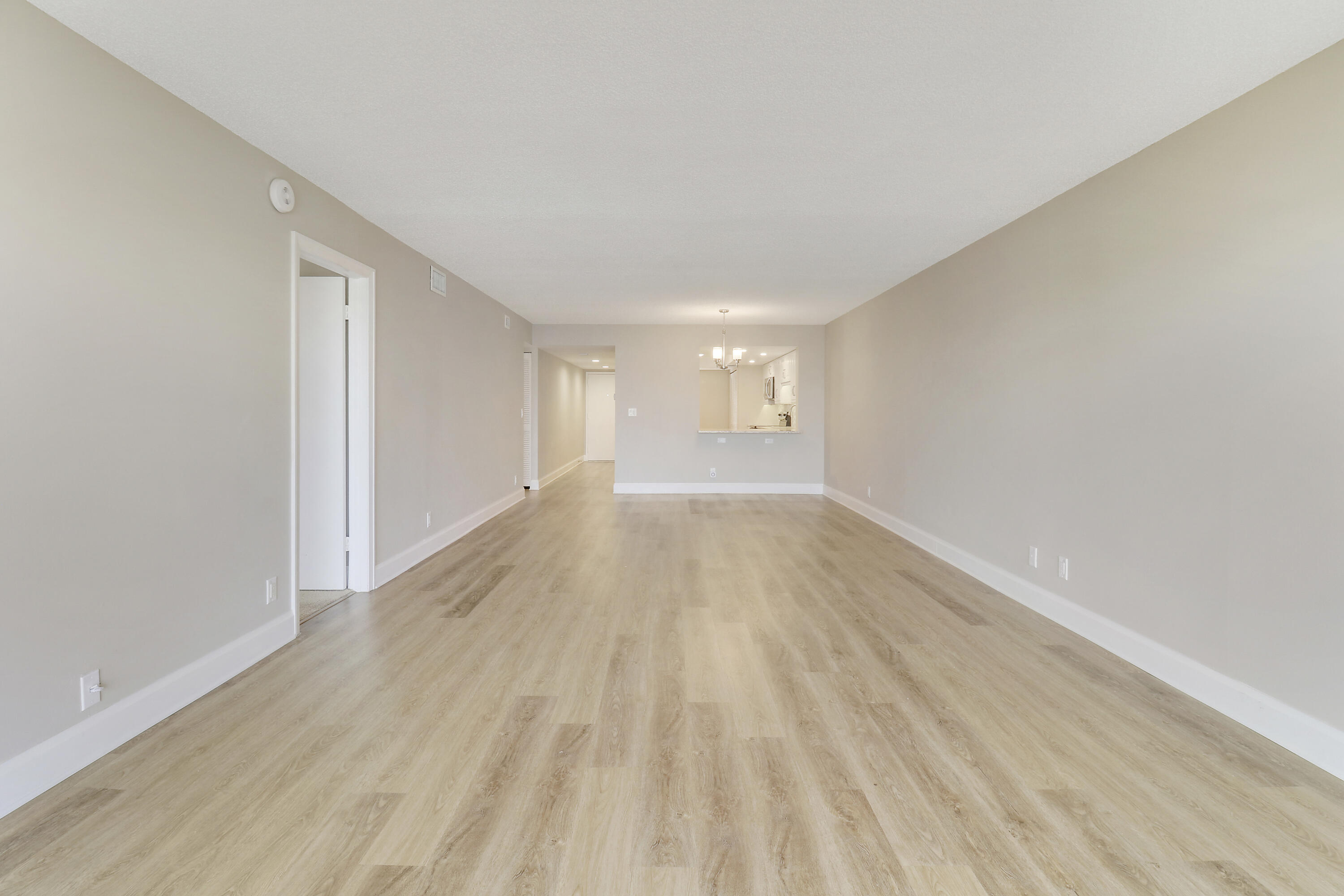 1036 Highway 1, Unit 321 North Palm Beach, FL 33408 - Photo 25 of 40 a view of an empty room with wooden floor and a window