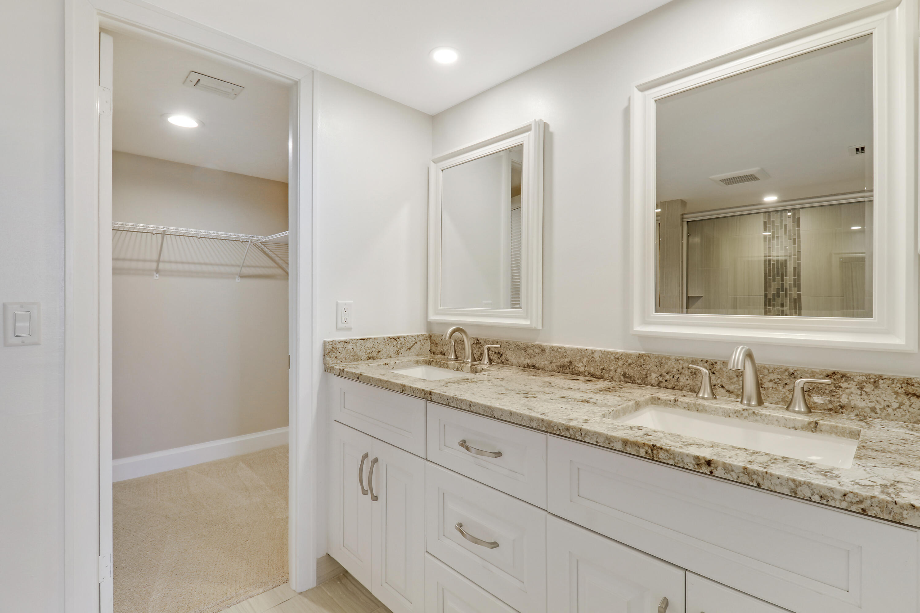 1036 Highway 1, Unit 321 North Palm Beach, FL 33408 - Photo 27 of 40 a bathroom with a granite countertop sink and a mirror