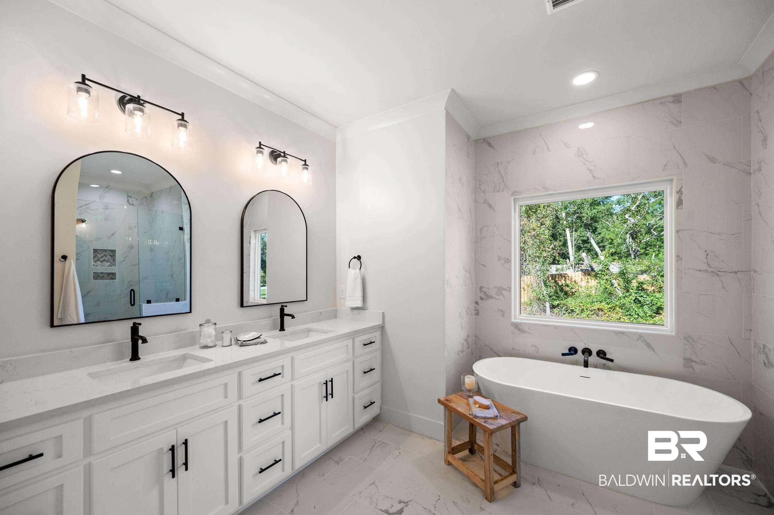 28889 Canal Road Orange Beach, AL 36561 - Photo 39 of 55 Bathroom with vanity, crown molding, independent shower and bath, and tile walls