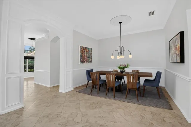 an empty room with a large window with a ceiling fan