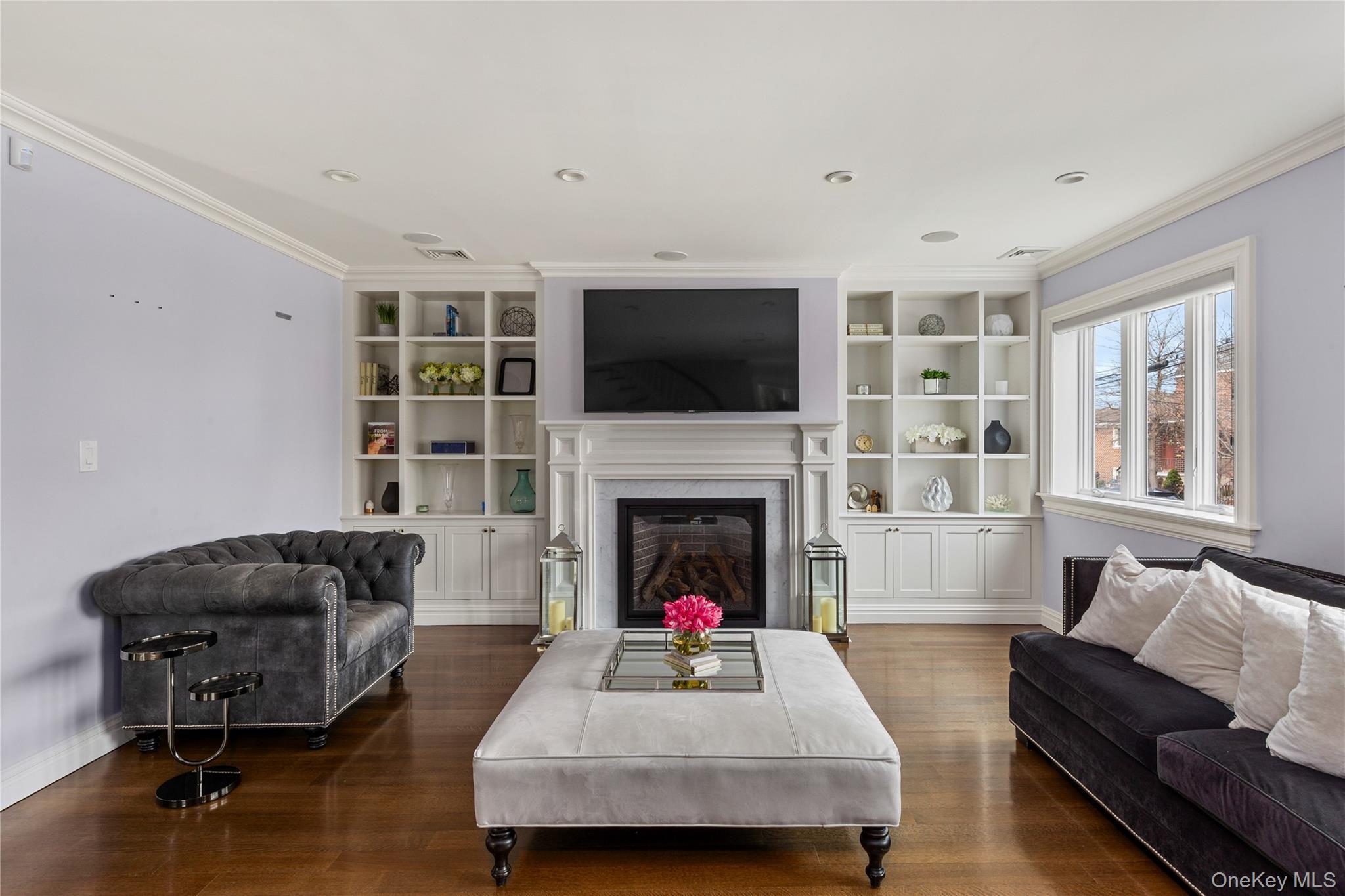 154-96 Riverside Drive Queens, NY 11357 - Photo 2 of 27 a living room with furniture a flat screen tv and a fireplace
