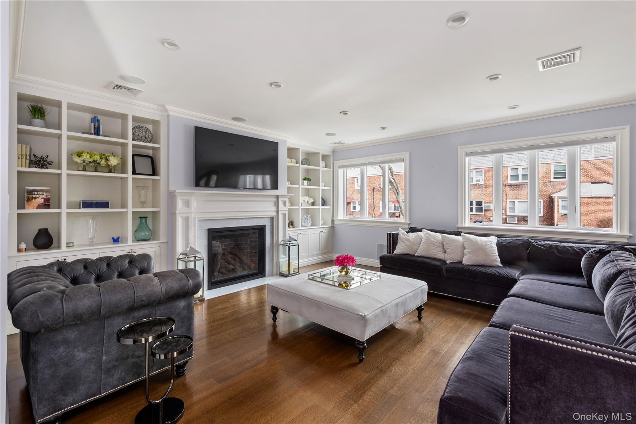 154-96 Riverside Drive Queens, NY 11357 - Photo 3 of 27 a living room with furniture a flat screen tv and a fireplace