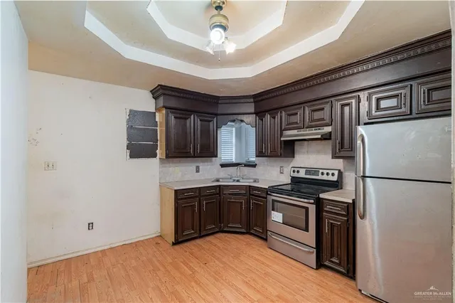 a kitchen with stainless steel appliances granite countertop a stove cabinets and refrigerator