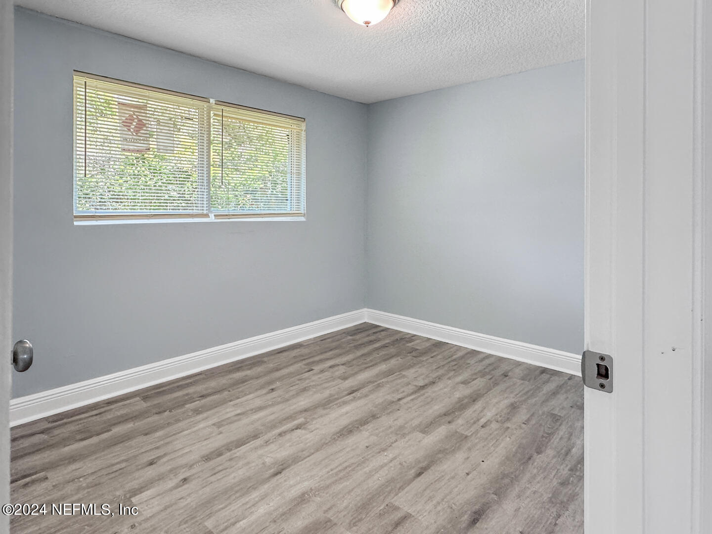 5142 Moncrief Road Jacksonville, FL 32209 - Photo 14 of 27 an empty room with wooden floor and windows