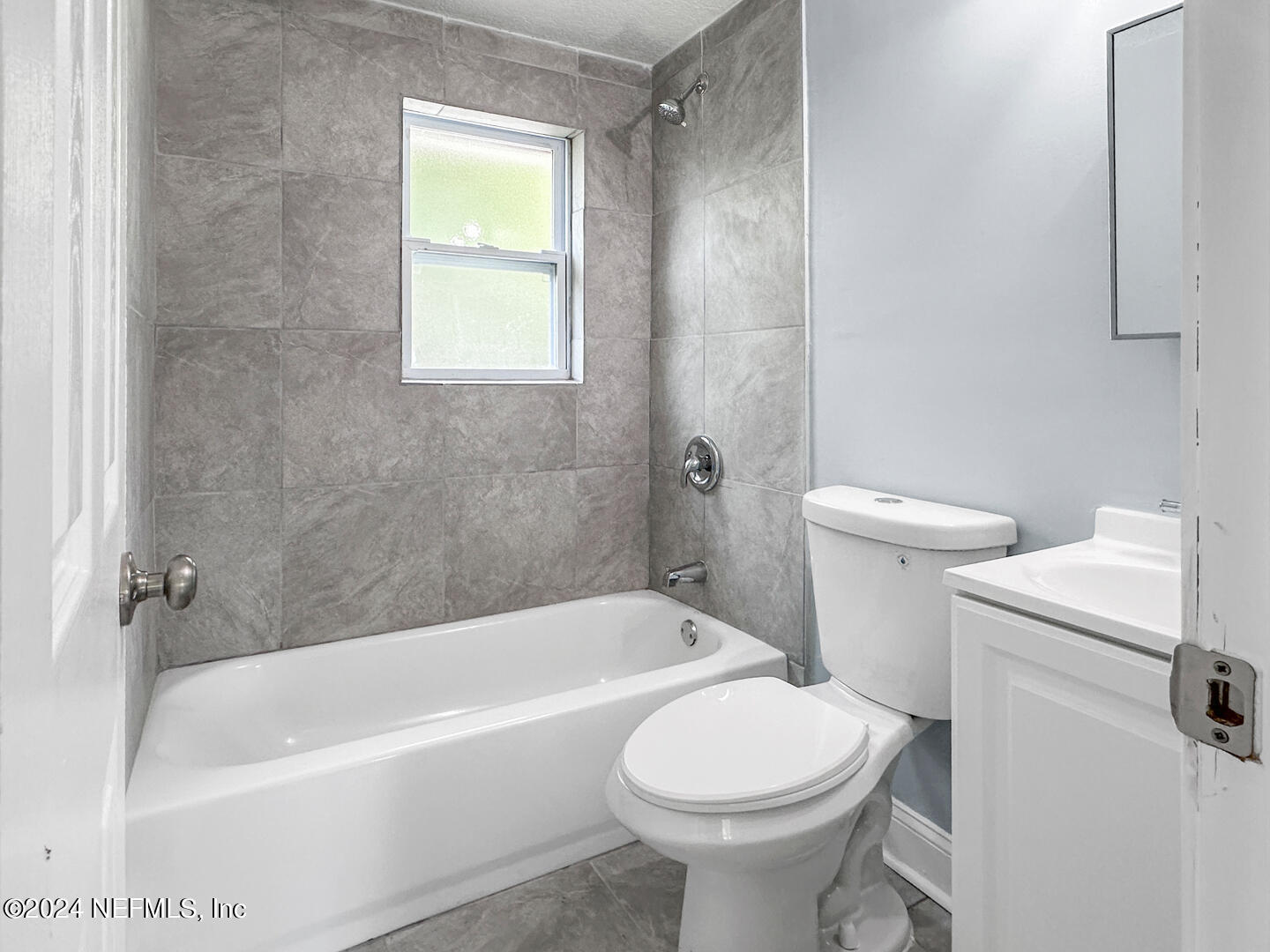 5142 Moncrief Road Jacksonville, FL 32209 - Photo 15 of 27 a bathroom with a sink a toilet and bathtub