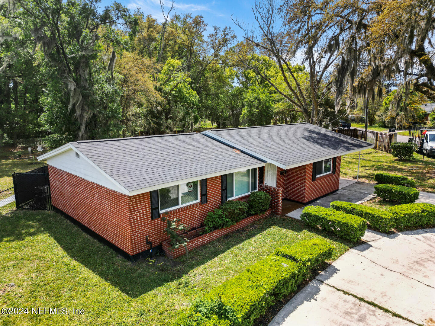 5142 Moncrief Road Jacksonville, FL 32209 - Photo 18 of 27 an aerial view of a house with yard and trees in the background