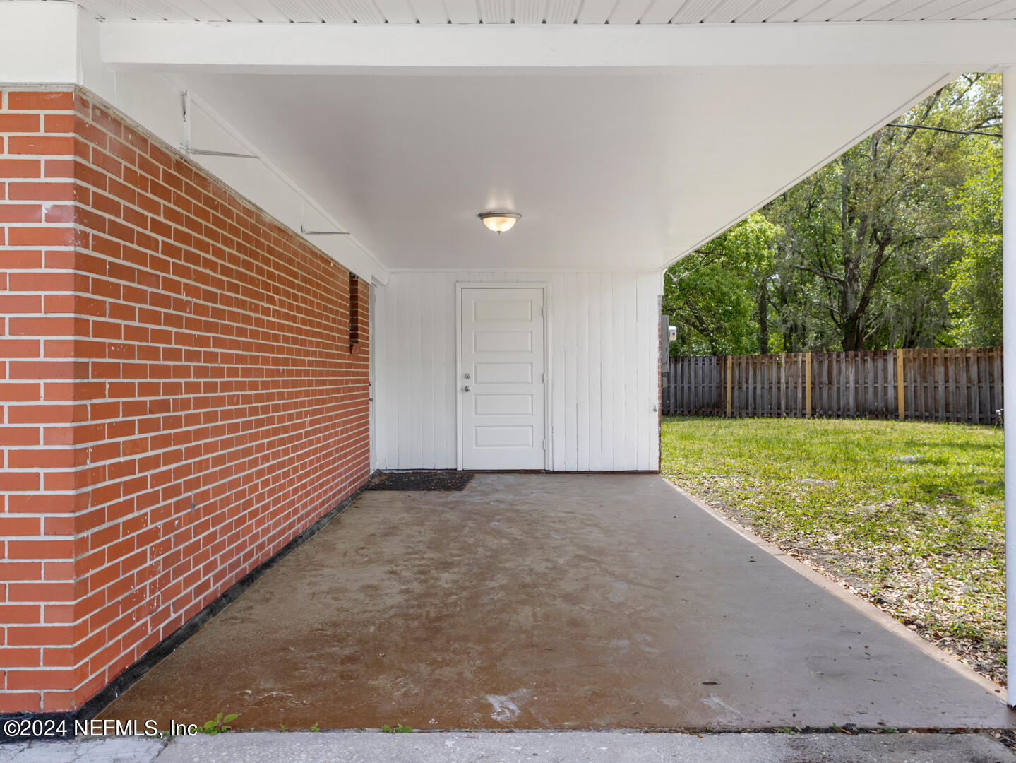 5142 Moncrief Road Jacksonville, FL 32209 - Photo 19 of 27 a view of a backyard with large trees and wooden fence