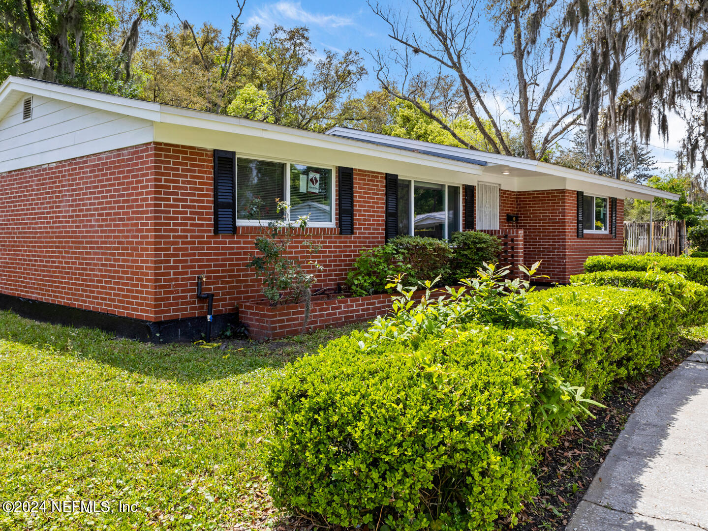 5142 Moncrief Road Jacksonville, FL 32209 - Photo 2 of 27 a view of a house with a large window and flower plants