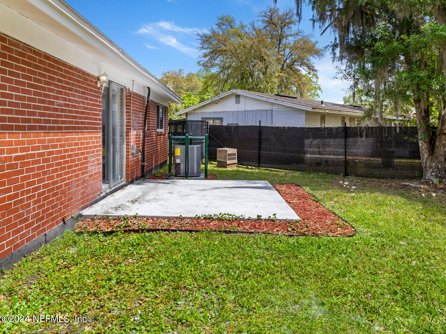5142 Moncrief Road Jacksonville, FL 32209 - Photo 21 of 27 a view of a backyard with a small cabin and a chair