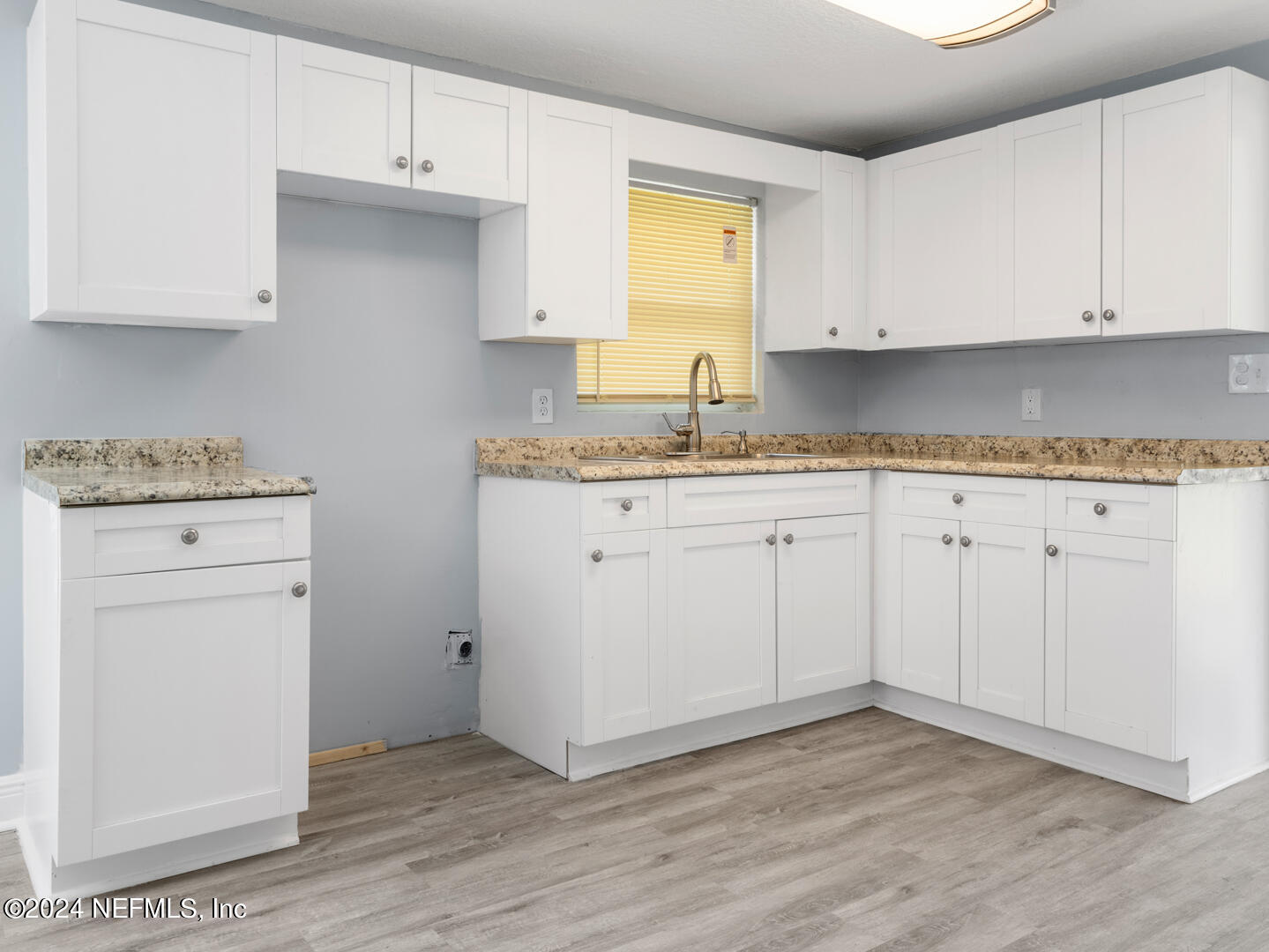5142 Moncrief Road Jacksonville, FL 32209 - Photo 6 of 27 a kitchen with granite countertop white cabinets and a stove with wooden floor
