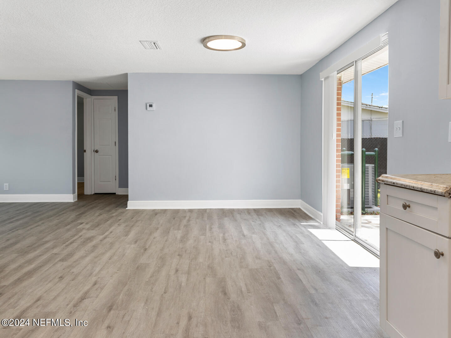 5142 Moncrief Road Jacksonville, FL 32209 - Photo 7 of 27 wooden floor in an empty room with a window