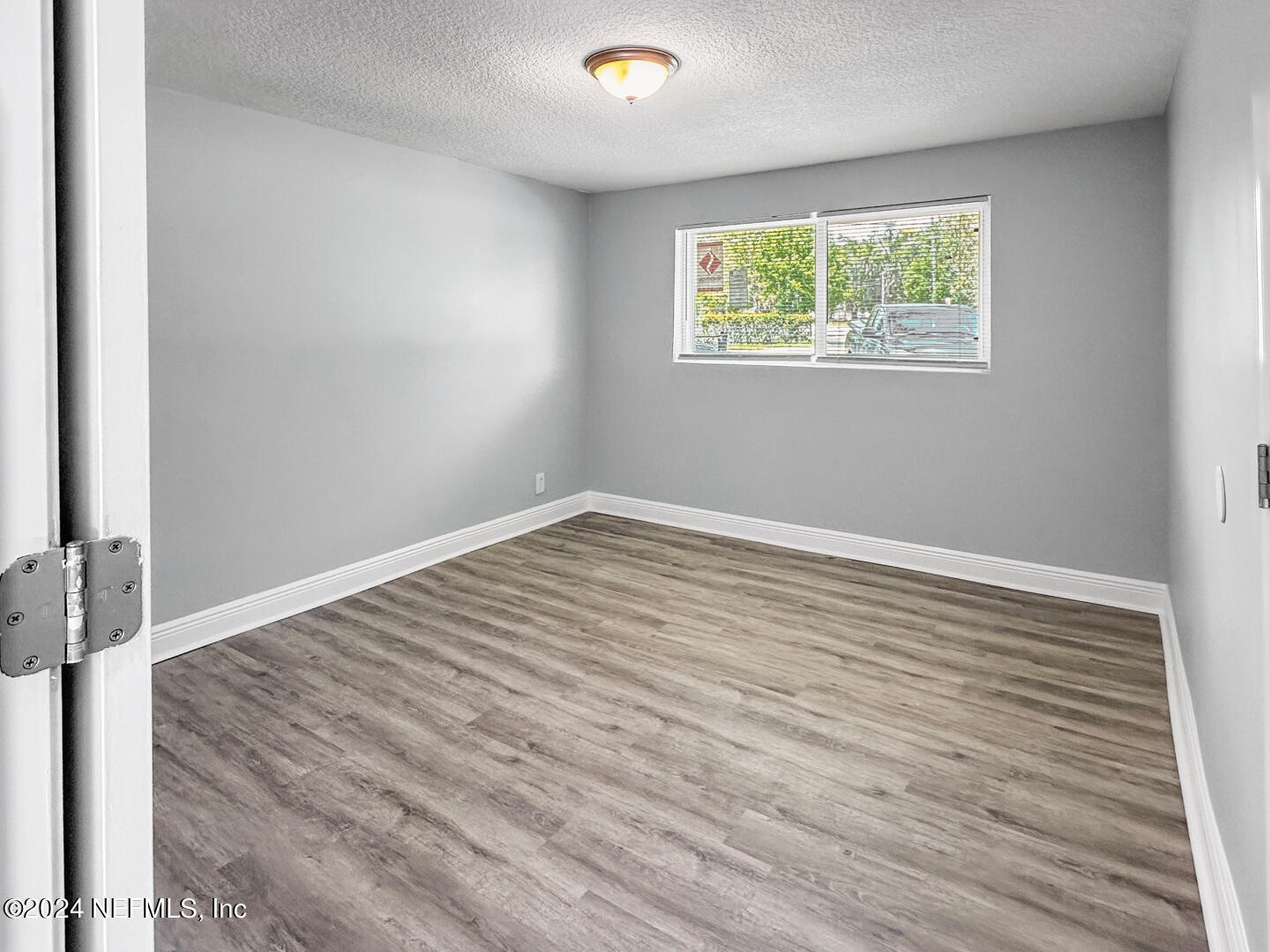5142 Moncrief Road Jacksonville, FL 32209 - Photo 10 of 27 a view of room with hardwood floor and window