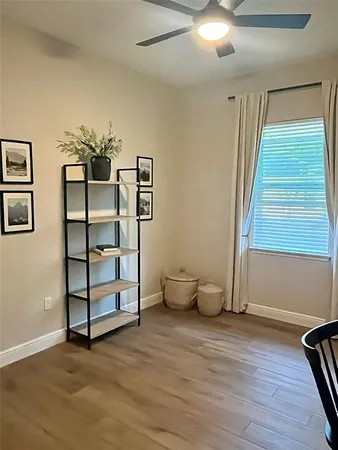 a view of a room with wooden floor and windows