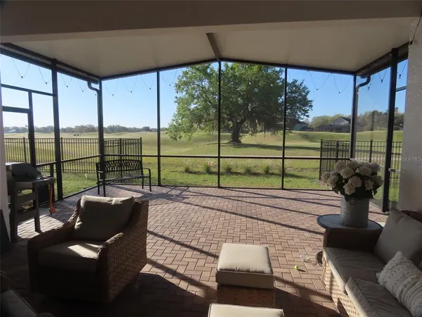a view of a living room and floor to ceiling window in an outdoor space